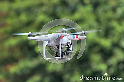 Quadcopter, quadrotor, drone on a green background. Stock Photo