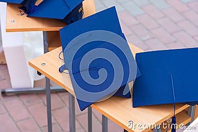 Quadrangular cap as a symbol of a graduate. Background with selective focus and copy space Stock Photo