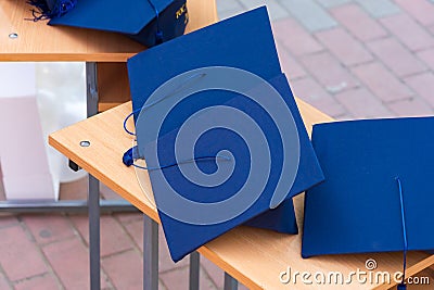 Quadrangular cap as a symbol of a graduate. Background with selective focus and copy space Stock Photo