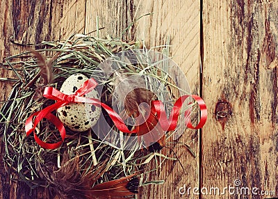 Quail easter egg with red ribbon Stock Photo