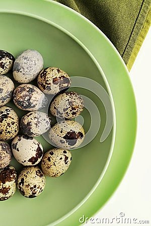 Quail easter eggs in a green plate. Stock Photo