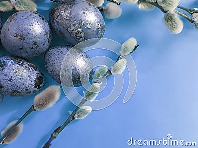 Quail eggs easter branch of a willow on a blue background Stock Photo
