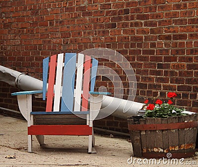 Quaint Americana Chair in alley with brick building Stock Photo