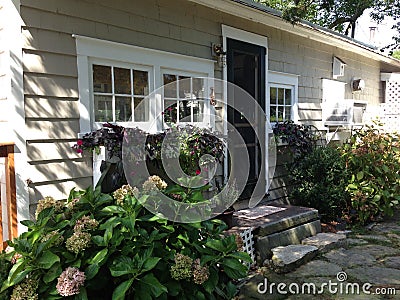 Quaint Cottage with flowers Stock Photo