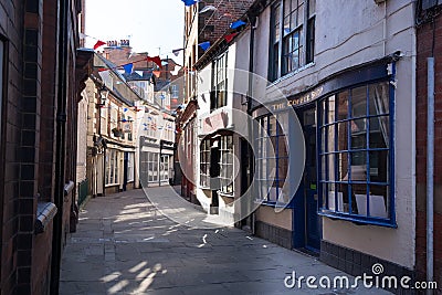 Quaint shopping street with georgian and victorian shop fronts in Whitby Editorial Stock Photo