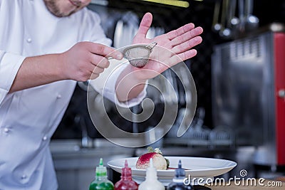 Qualified cook preparing a very tasty dessert Stock Photo