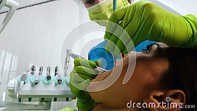 Qualified dentist drilling lady patients tooth, removing caries, dental services Stock Photo