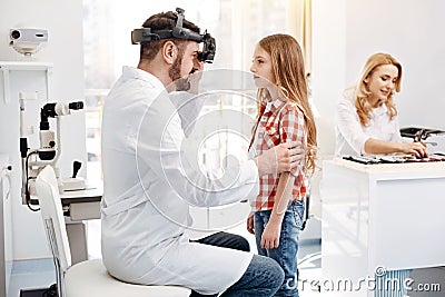 Qualified prominent doctor doing a checkup on girls eyes Stock Photo