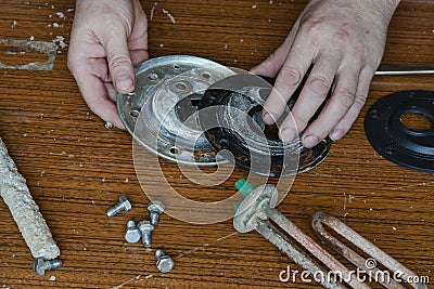 Locksmith performs inspection, disassembly and fault finding of the boiler Stock Photo