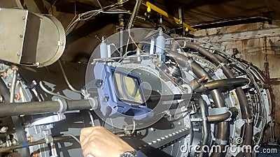 Quality control engineer calibrates turbines temperature monitoring system, ensuring accurate sensor readings. Correct Stock Photo