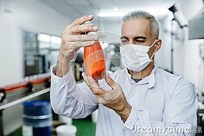 Quality control and food safety inspector test and check product contaminate standard in the food and drink factory production Stock Photo