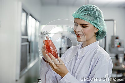 Quality control and food safety inspector test and check product contaminate standard in the food and drink factory production Stock Photo