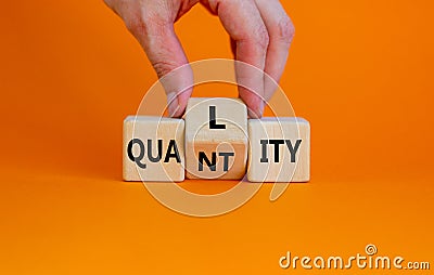 Quality over quantity symbol. Businessman turns cubes and changes the word `quantity` to `quality`. Beautiful orange table, or Stock Photo