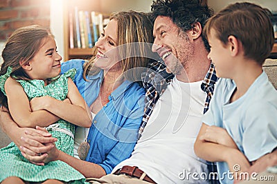 Quality time strengthens family ties. a happy family relaxing on the sofa together at home. Stock Photo