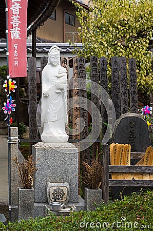 Quan Yin with child statue at Koanin Buddhist Temple. Editorial Stock Photo