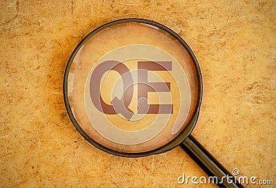 Quantitative easing magnifying glass Stock Photo