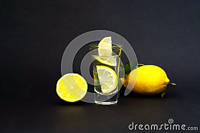 Quarantini or homemade tequila. Alcoholic drink covid with lemon on dark background. The concept of new popular drinks. Close-up Stock Photo