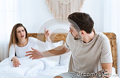 Quarrel in bed. Young couple passionately finds out relationship Stock Photo