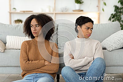 Quarrel of friends, problems and resentment. Angry and mad two millennial african american ladies Stock Photo