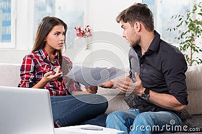 Quarreled couple with unpaid bills Stock Photo