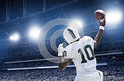 Quarterback throwing a football in a professional football game Stock Photo