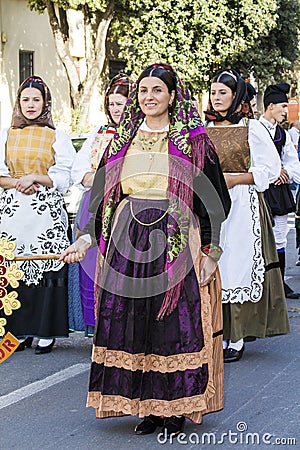 QUARTU S.E., ITALY - September 17, 2016: Parade of Sardinian costumes and floats for the grape festival in honor of the Editorial Stock Photo