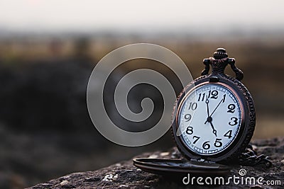 Quartz pocket analog watch kept on a rock Stock Photo