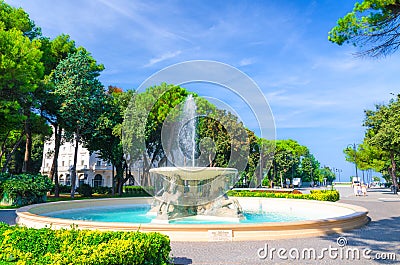 Quattro cavalli Four horses fountain with turquoise water in Parco Federico Fellini park with green trees in Rimini Stock Photo