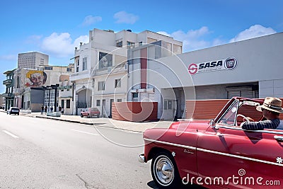Quay Malecon, Havana, Cuba - 30/03/2018: Unknown person in red retro car Editorial Stock Photo