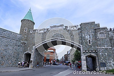 tourists stroll in front of historic fortified wall on downtown of Quebec City, Canada Editorial Stock Photo