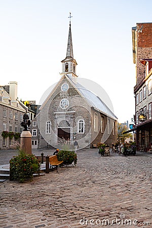 The 17th Century Place Royale, with the historic Notre-Dame-des-Victoires church and patrons at the Café Smith Editorial Stock Photo