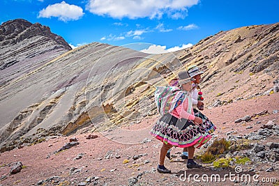 Quechua girls follow trails in the Andes on the Ausangate trek. Cusco, Peru Editorial Stock Photo