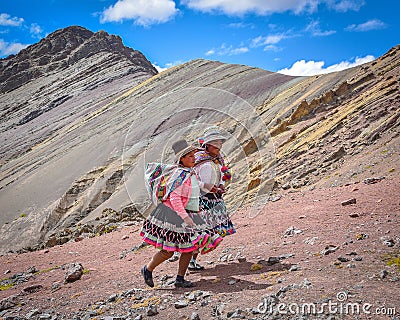 Quechua girls follow trails in the Andes on the Ausungate trek. Cusco, Peru Editorial Stock Photo