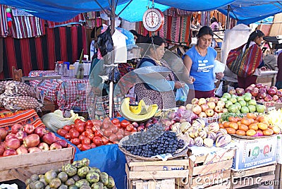 Quechua Indian women bargain and sell vegetables > Editorial Stock Photo