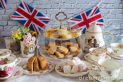 Queen Elizabeth II Platinum Jubilee cream tea street party food red white and blue flags with celebration Union jack food toppers Stock Photo