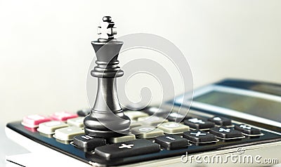 queen and king in front of the battlefield of fallen chess pieces sacrifices, black background with smoke and copy space Stock Photo