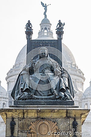 Queen Victoria Monument with Victoria Memorial`s central dome in the background. Kolkata, India. A vertical version Editorial Stock Photo