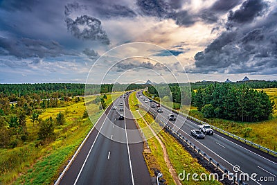 Queensland, Australia - Cars moving along Bruce Hwy with Glass House mountains in the background Editorial Stock Photo