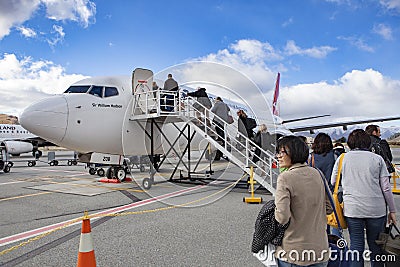 QUEENSTOWN NEW ZEALAND - SEPTEMBER 6: passenger preparing to flight by qantas airline to sydney at queenstown airport on Editorial Stock Photo