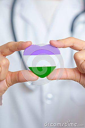 Queer Pride Day and LGBT pride month concept. Doctor hand holding purple, white and green heart shape with Stethoscope for Lesbian Stock Photo