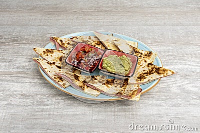 The quesadilla consists of a corn or wheat tortilla, folded in half that can Stock Photo