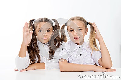 Question and answer. little school girls know answer to question. i know. little school girls with raised hands. Stock Photo