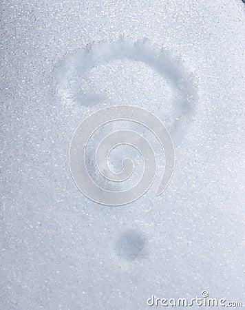 Question mark drawn on white snow on a winter day Stock Photo
