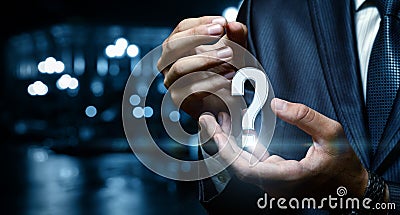 Question mark in the hand of businessman over city background. Stock Photo