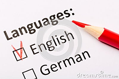 Questionnaire concept. Languages with English and German checkboxes with red pencil. Close up image Stock Photo