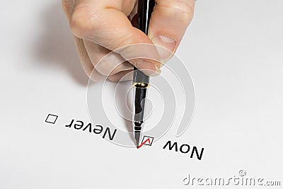 Question. Make a decision now or never. Red checkmark on white paper. Stock Photo