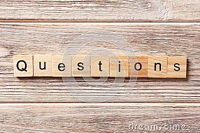 Questions word written on wood block. Questions text on table, concept Stock Photo