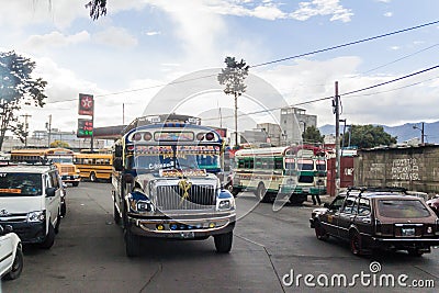 QUETZALTENANGO, GUATEMALA - MARCH 21, 2016: Colourful chicken buses, former US school buses, ride in Quetzaltenango cit Editorial Stock Photo