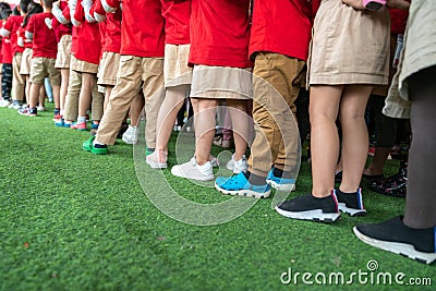 Queue of Asian kids in school uniform standing in line Editorial Stock Photo