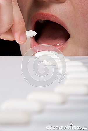 Queue of chewing gums heading to open mouth Stock Photo